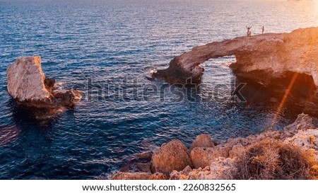 A beautiful evening on a natural stone bridge (Lovers' Bridge) near Ayia Napa in Cyprus. Bridge of love at sunset. Cavo Greco Royalty-Free Stock Photo #2260832565