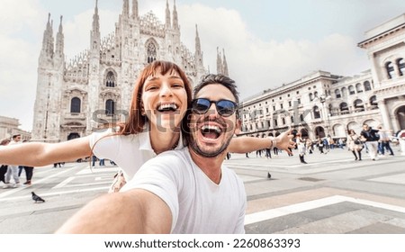 Happy couple taking selfie in front of Duomo cathedral in Milan, Lombardia - Two tourists having fun on romantic summer vacation in Italy - Holidays and traveling lifestyle concept Royalty-Free Stock Photo #2260863393