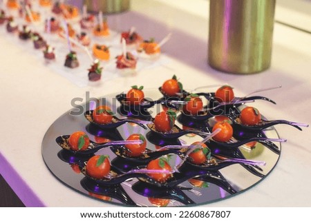 Beautifully decorated banquet catering table with variety of different food snacks, sandwiches, croissants and appetizers on a party event or celebration, delicatessen setting, coffee break

