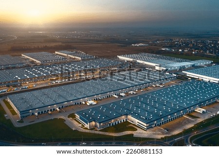 Top view of warehouses, aerial view of large logistics warehouses in the evening Royalty-Free Stock Photo #2260881153