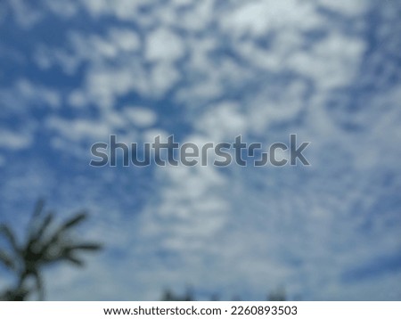 blurry picture of blue sky with clouds 
