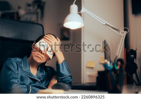 
Funny Busy Woman Working at Night Trying to Stay Awake. Sleepy office worker trying to finish a project at home instead of resting
