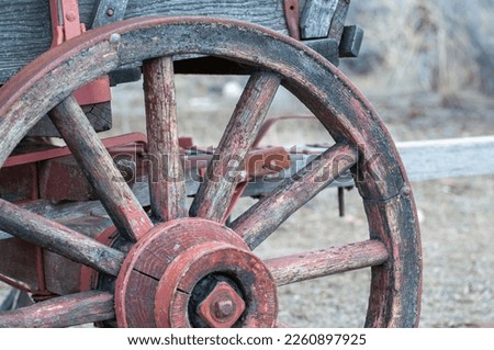 Closeup up wagon wheel red faded paint Royalty-Free Stock Photo #2260897925