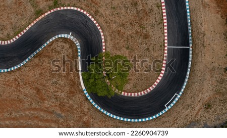 Aerial top view motorsport race asphalt circuit motor racing track, Race track, Curving race track view from above, Aerial view car race asphalt track and curve. Royalty-Free Stock Photo #2260904739