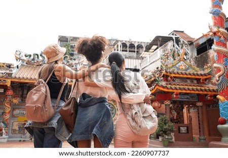 group of multi-ethnic female friends diversity enjoying the city tour. Young tourists having fun in China town. Royalty-Free Stock Photo #2260907737