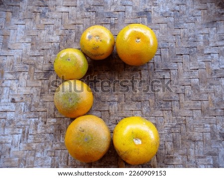 a pile of citrus fruits that form the letter c as a fruit rich in vitamin c. orange fruits