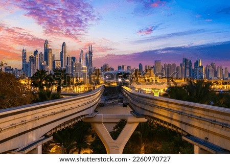dubai monorail night view of a moving carriage on the background of a night city with skyscrapers, sunset sky