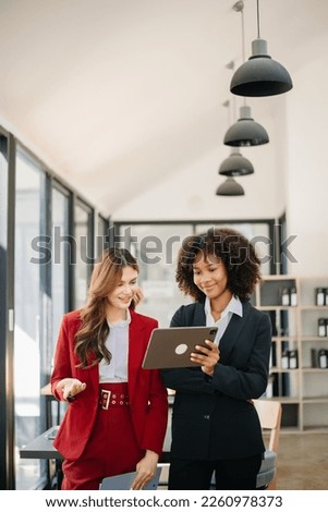 Two business workers talking on the smartphone and using laptop at the modrrn office.
 Royalty-Free Stock Photo #2260978373