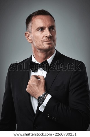 Fashion, success and mature man in tuxedo, handsome online dating profile picture isolated on grey background in studio. Luxury, rich elegant celebrity actor style and date for valentines day.