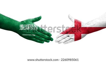 Handshake between England and Saudi Arabia flags painted on hands, isolated transparent image.