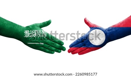 Handshake between Laos and Saudi Arabia flags painted on hands, isolated transparent image.