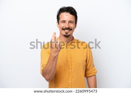 Young man with moustache isolated on white background doing coming gesture