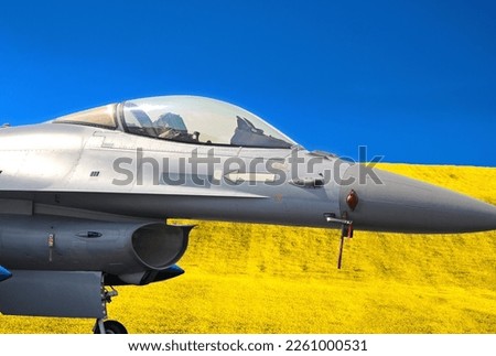 Collage of air fighter and Ukraine flag from Blue sky and yellow field. Royalty-Free Stock Photo #2261000531