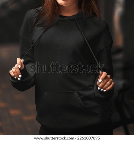 Young woman model wearing black women's hoodie, mockup for your own design. Street style photo Royalty-Free Stock Photo #2261007895