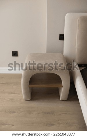 Beige bedside table in a modern interior