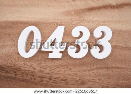 White number 0433 on a brown and light brown wooden background.