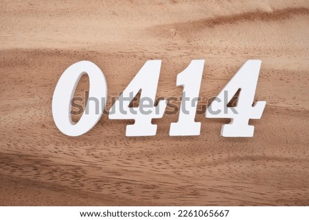 White number 0414 on a brown and light brown wooden background.