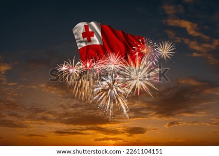 Flag of Tonga and Holiday fireworks in majestic sky of National Independence day Royalty-Free Stock Photo #2261104151