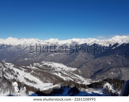 Mountain peaks, blue sky, winter. High quality photo