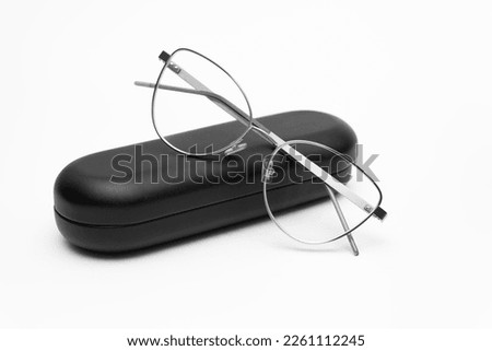 Beautiful women's glasses with a case. Black and white photogravure of female glasses with box Royalty-Free Stock Photo #2261112245