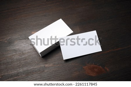 Blank business cards on wood table background. Mockup for branding identity. Template for graphic designers portfolios.