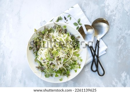Kohlrabi salad with slivered almonds, Feta cheese, greens olive oil and lemon juice Royalty-Free Stock Photo #2261139625
