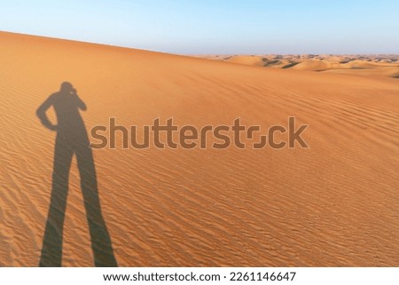 Shadow of a man on the dunes of the Empty Quarter in Saudi Arabia