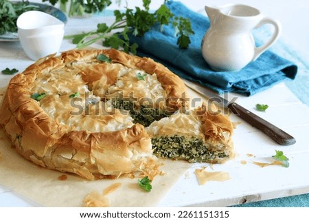 Traditional Greek cuisine. Spanakopita, savory pie. Homemade Greek phyllo dough pie filled with spinach and feta cheese. 