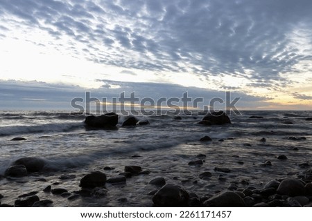 Rocks at the shoreline at dawn as sea wallpaper.