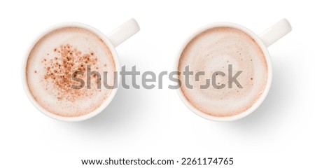 two white mugs with hot chocolate, with and without chocolate powder, isolated over a white background, hot drink beverage design element, flat lay, top view