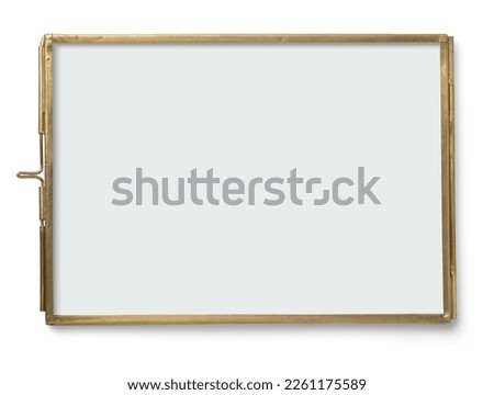 contemporary brass frame with glass on both sides for photos, flat objects like pressed flowers or other memories, isolated over a white background, great as design element for wedding flatlays