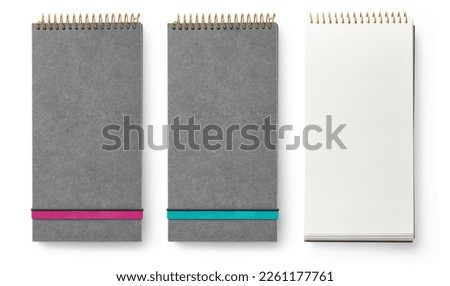 long vertical grey notebooks ring binders with elastic band closure in two colors (pink and teal) and open, great for check or to-do lists, shopping lists, notes, isolated over transparent background