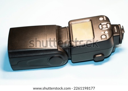 On-camera flash for camera on isolated blue background