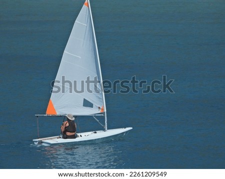 Zoom photo of beautiful sail boat powered by wind cruising near deep blue sea of Lefkada island, Ionian, Greece