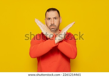 Bearded hispanic man wearing red jumper isolated keeping two arms crossed, denial concept