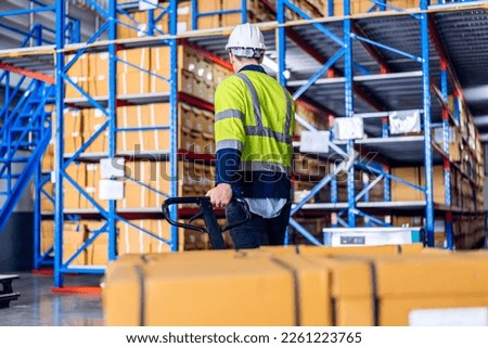 Portrait engineer worker labor man work shipping order detail check goods and supplies on shelves with goods background inventory in factory warehouse.logistic industry and business export