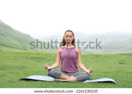 Front view portrait of a yogi doing yoga a foggy day Royalty-Free Stock Photo #2261230235