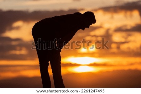 A Muslim prayer man praying at sunset.