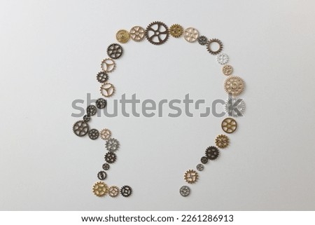 Many different gears shaped as human head on white background. Creativity, new ideas and thinking concept.