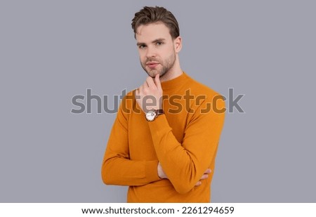 serious man with watch. photo of man. man isolated on grey background. man in studio