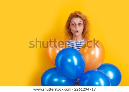 party woman with balloon in sunglasses. shocked woman hold party balloons in studio.