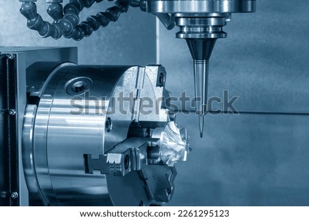 The 5-axis CNC milling machine  cutting the turbocharger part with solid ball end mill tool. The hi-technology automotive  parts manufacturing process by 5-axis machining center. Royalty-Free Stock Photo #2261295123