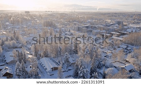 White and snowy landscape from the village. Aerial view of beautiful winter weather in Korso Vantaa, Finland