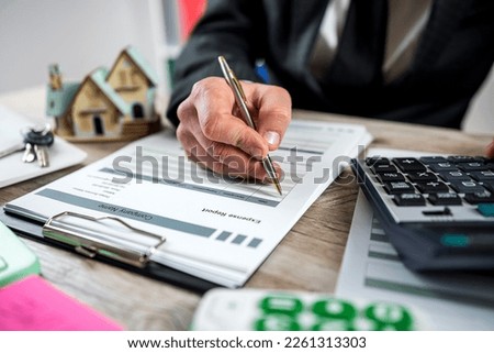businessman is preparing a contract for the lease or sale of property in the office