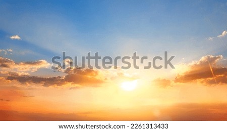 Dramadic Sunset Sky blue and orange light of the sun through the clouds in the sky Royalty-Free Stock Photo #2261313433