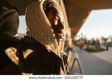 african woman by the wall sunset