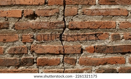 Photo of a brick wall that is cracked from old age