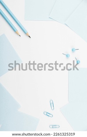 Notebook and Colored Papers Stickers Lying On White Desk. Multiple Assorted Collection Office Stationery. Photo With Pens Pencils Rullers Calculators.