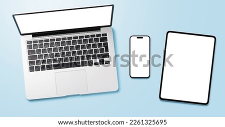 Laptop, tablet and smartphone with blank screen on blue background. Flat lay with copy space Royalty-Free Stock Photo #2261325695