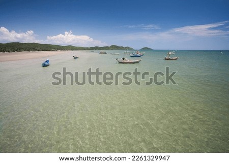 
Coastline, white sand, emerald green sea blue sky Is a small fishing boat and equipment used for fishing. Buoys with colorful flags, ropes, bamboo and pictures of the fisherman's way of life.